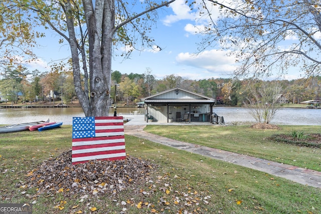 dock area featuring a lawn and a water view