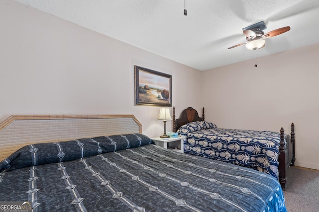 carpeted bedroom with a textured ceiling and ceiling fan