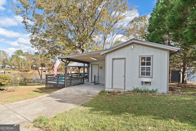 view of outbuilding with a lawn and a carport