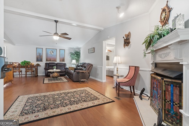 living room with lofted ceiling with beams, ceiling fan, wood-type flooring, and crown molding