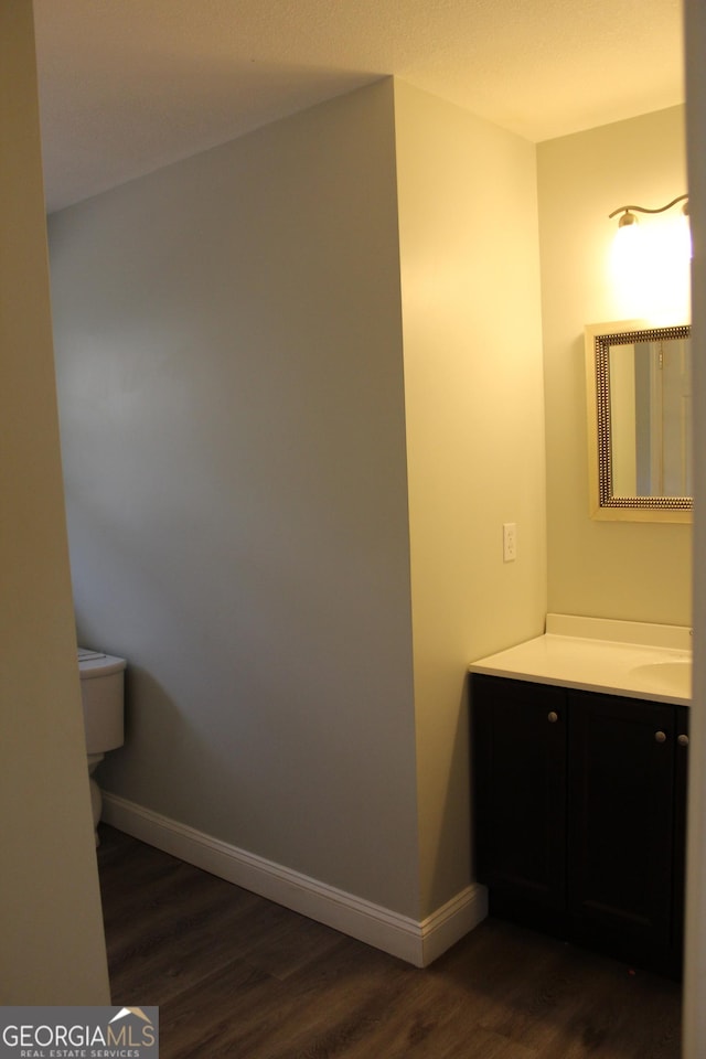 bathroom featuring hardwood / wood-style flooring, vanity, and toilet