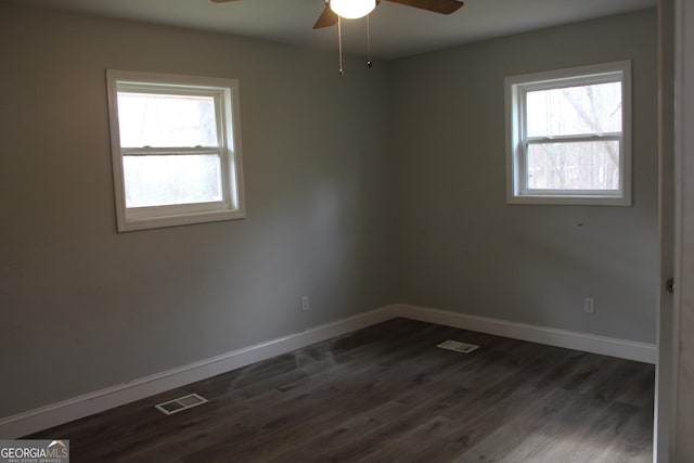 unfurnished room with ceiling fan, a healthy amount of sunlight, and dark hardwood / wood-style flooring