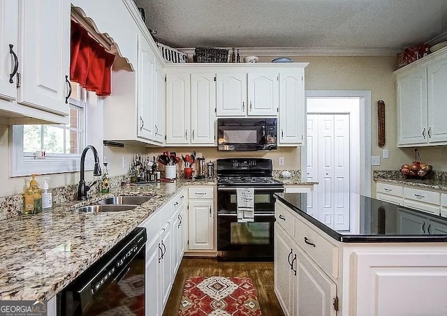 kitchen with black appliances, a sink, dark wood-style flooring, white cabinets, and a textured ceiling