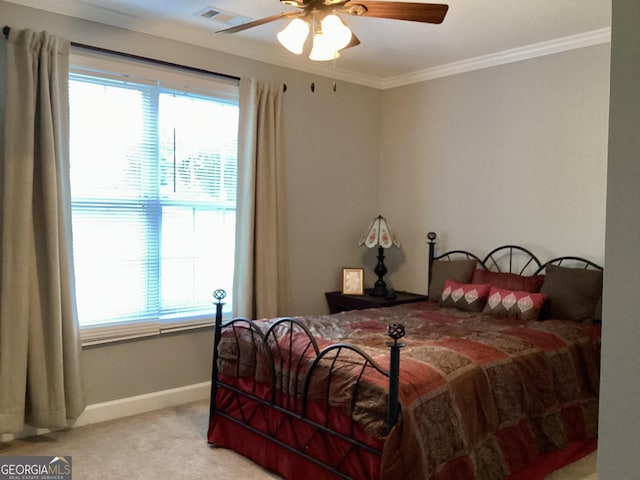 carpeted bedroom featuring baseboards, ornamental molding, and a ceiling fan