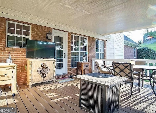 wooden deck featuring outdoor dining area