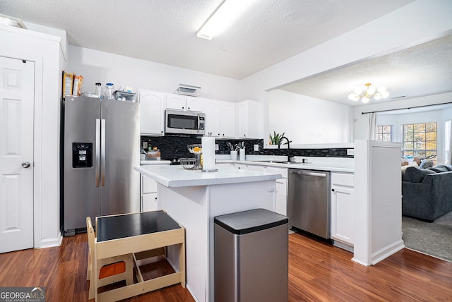 kitchen featuring white cabinetry, dark wood-type flooring, and stainless steel appliances