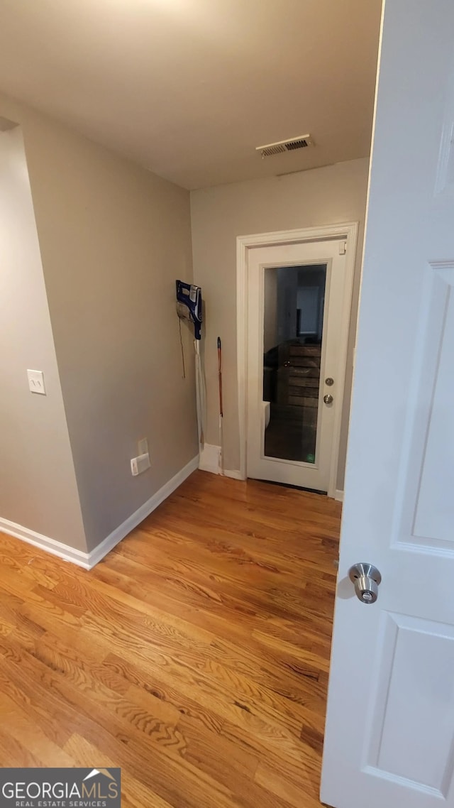 corridor with light wood-type flooring