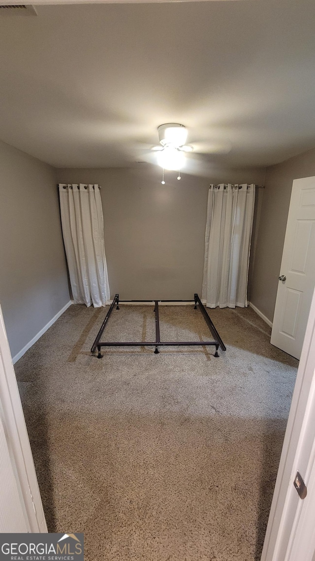 unfurnished bedroom featuring carpet floors and ceiling fan