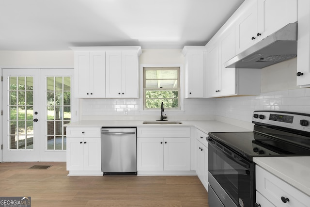 kitchen with sink, french doors, light hardwood / wood-style flooring, white cabinets, and appliances with stainless steel finishes