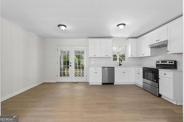 kitchen with appliances with stainless steel finishes, white cabinetry, french doors, and sink