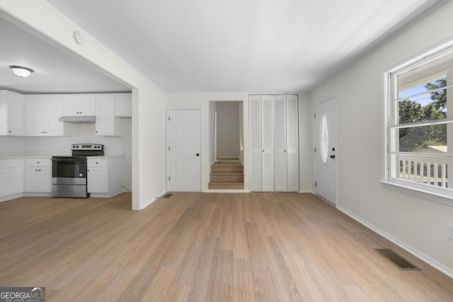 unfurnished living room with light wood-type flooring