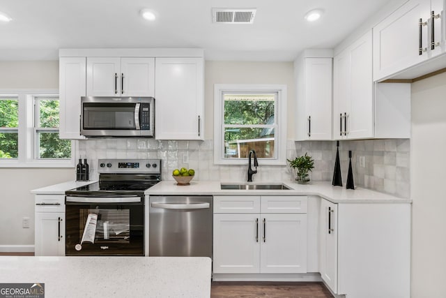 kitchen with white cabinetry, sink, and appliances with stainless steel finishes