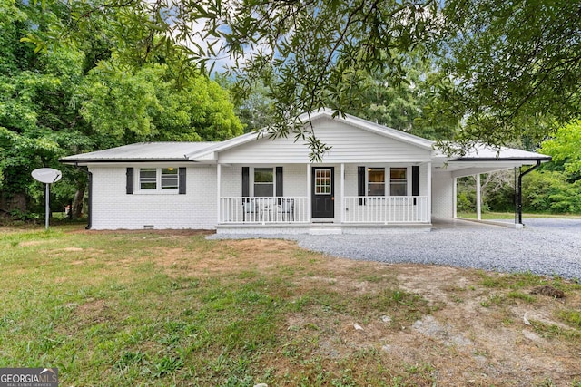 ranch-style house featuring a carport, covered porch, and a front lawn