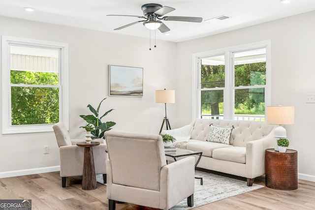 living room featuring light hardwood / wood-style flooring and ceiling fan