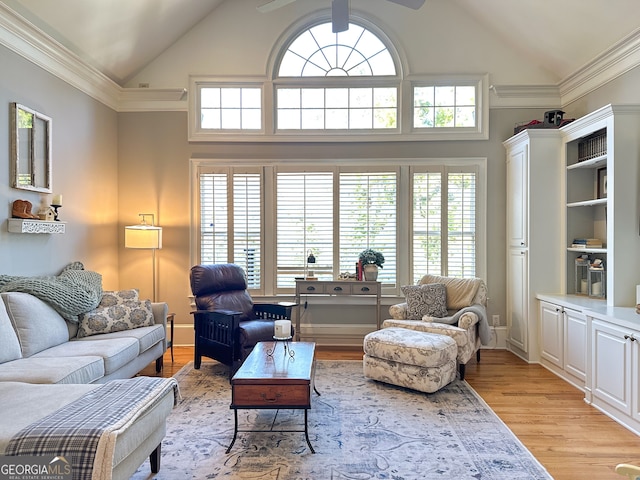 living room featuring ceiling fan, crown molding, lofted ceiling, and light wood-type flooring