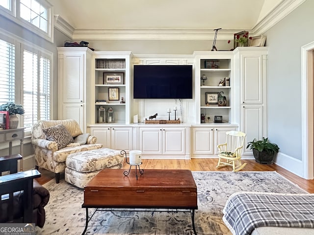 interior space featuring light wood-type flooring and crown molding