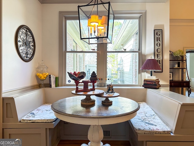 dining room featuring breakfast area and an inviting chandelier