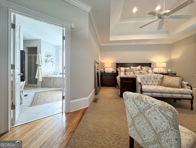 bedroom featuring ceiling fan, crown molding, light hardwood / wood-style flooring, and a raised ceiling