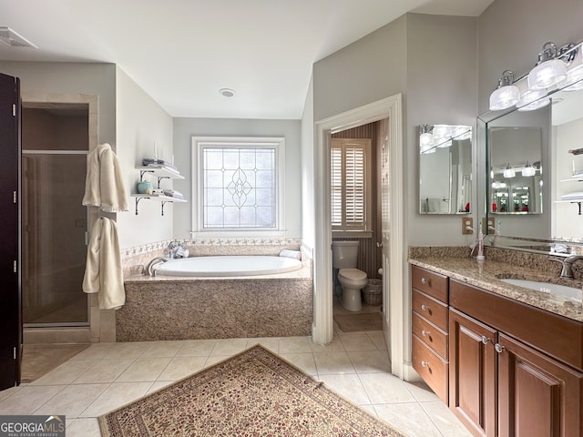 full bathroom featuring toilet, vanity, separate shower and tub, and tile patterned flooring