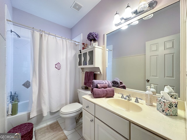 full bathroom featuring toilet, vanity, tile patterned flooring, and shower / bath combination with curtain