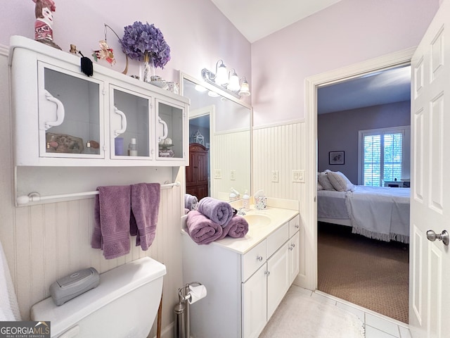 bathroom featuring toilet, vanity, and tile patterned flooring