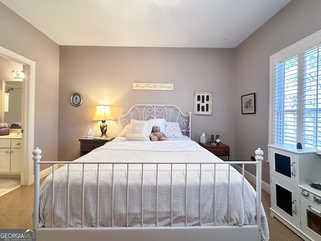 carpeted bedroom featuring connected bathroom