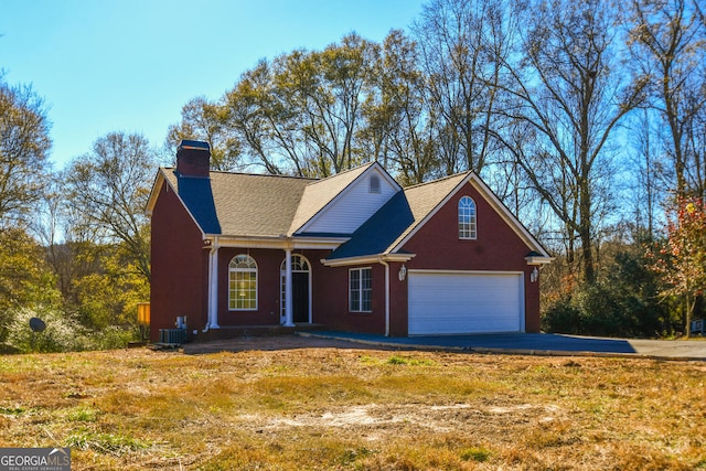 view of front of home with central AC unit and a garage