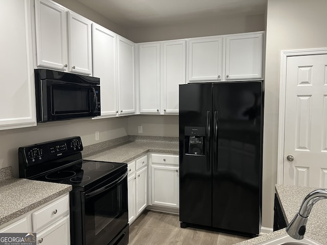 113 Ellis Dr, Conyers, GA 30012 - kitchen featuring black appliances, white cabinetry, and light countertops