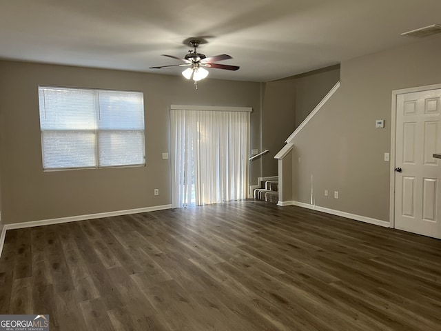 unfurnished living room featuring dark hardwood / wood-style floors and ceiling fan