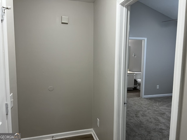 hall featuring dark colored carpet