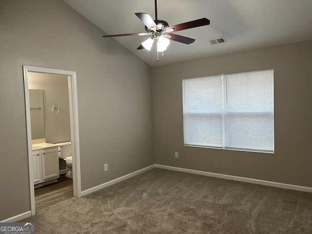 unfurnished bedroom with carpet, ceiling fan, lofted ceiling, and ensuite bathroom