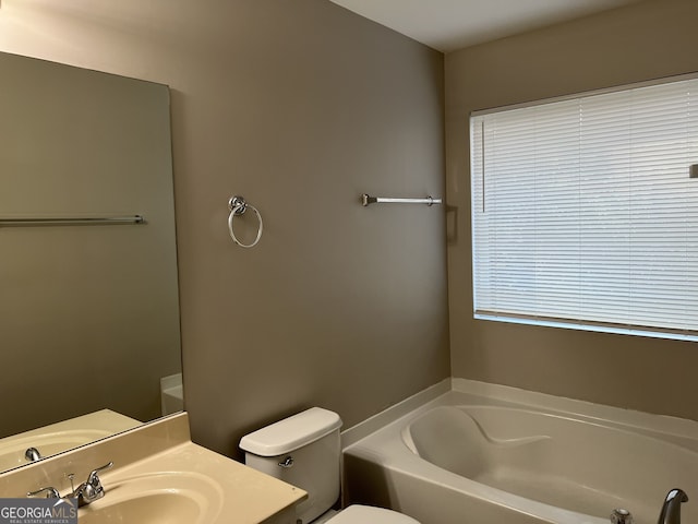 bathroom featuring vanity, toilet, and a bath