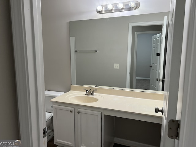 bathroom featuring vanity and toilet