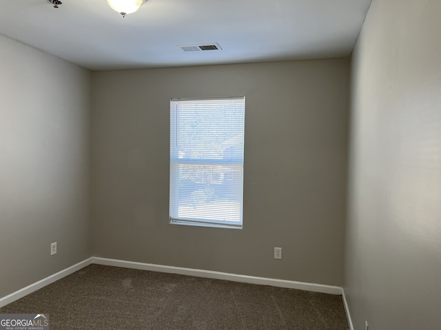 113 Ellis Dr, Conyers, GA 30012 - empty room with dark colored carpet and fire sprinkler in ceiling