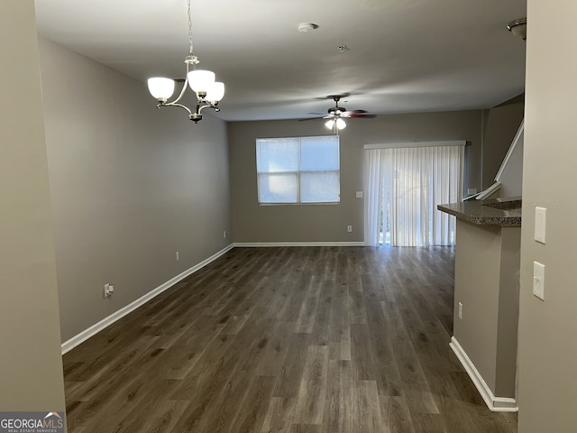 interior space with dark hardwood / wood-style flooring and ceiling fan with notable chandelier