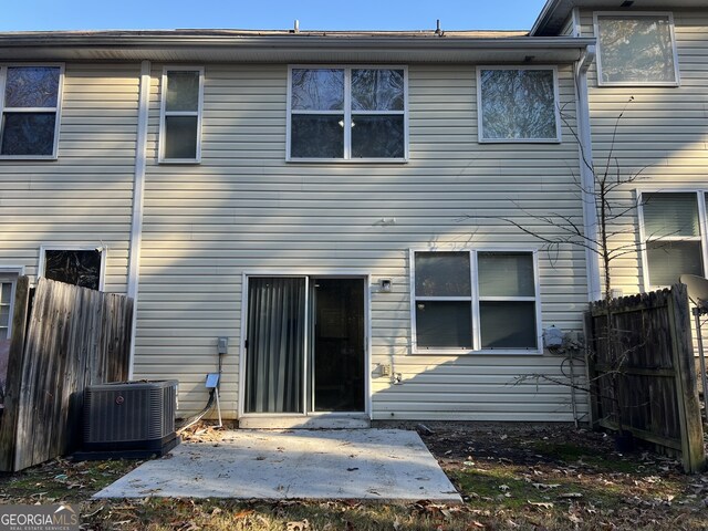 rear view of house with a patio and central air condition unit