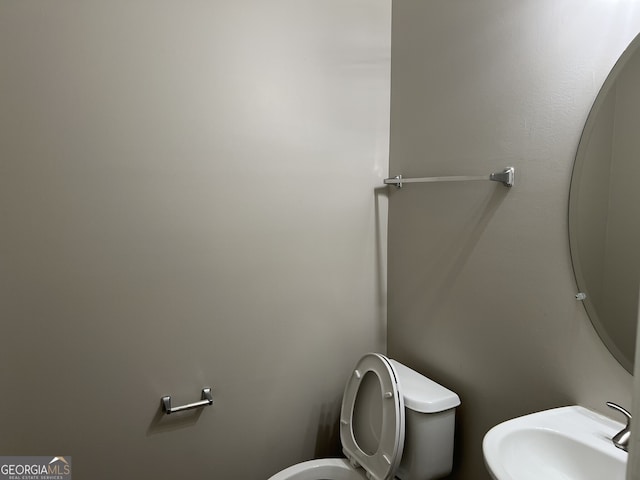 bathroom featuring sink and toilet