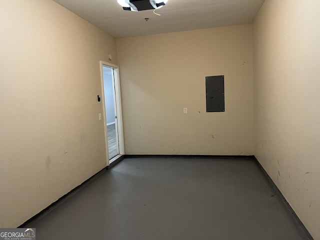 empty room featuring concrete flooring and electric panel