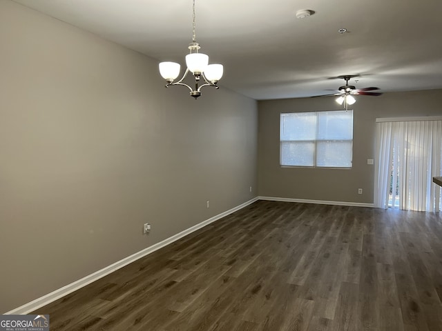 unfurnished room featuring dark hardwood / wood-style flooring and ceiling fan with notable chandelier