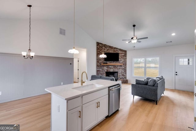 kitchen featuring white cabinetry, dishwasher, sink, a center island with sink, and light wood-type flooring