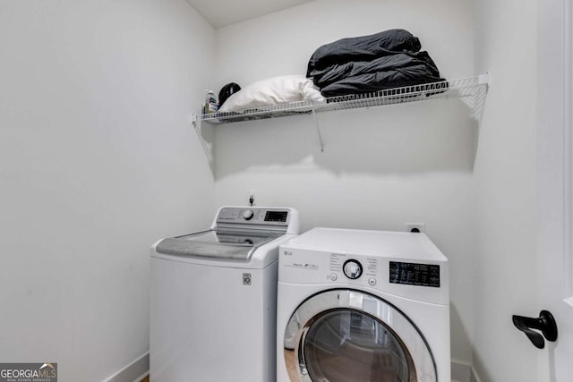 clothes washing area featuring washing machine and dryer