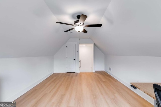 additional living space featuring light wood-type flooring, vaulted ceiling, and ceiling fan