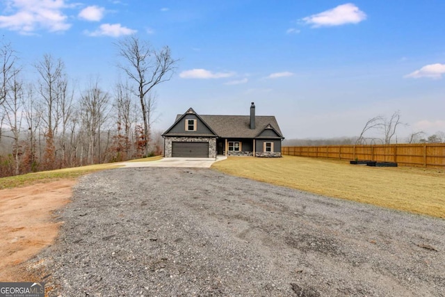 view of front of house with a garage and a front lawn