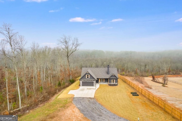 view of front of property featuring a front yard and a garage