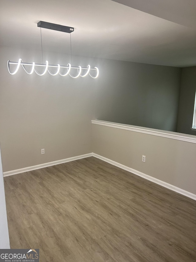 unfurnished room featuring dark wood-type flooring