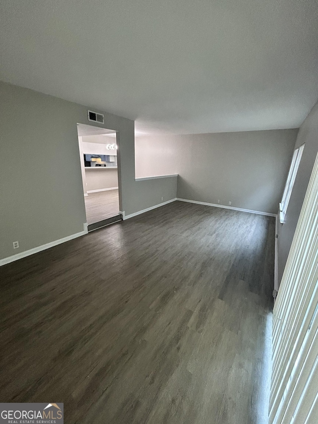 empty room featuring dark hardwood / wood-style flooring