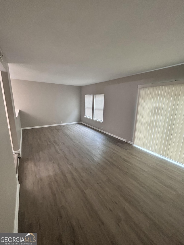 empty room featuring dark hardwood / wood-style flooring