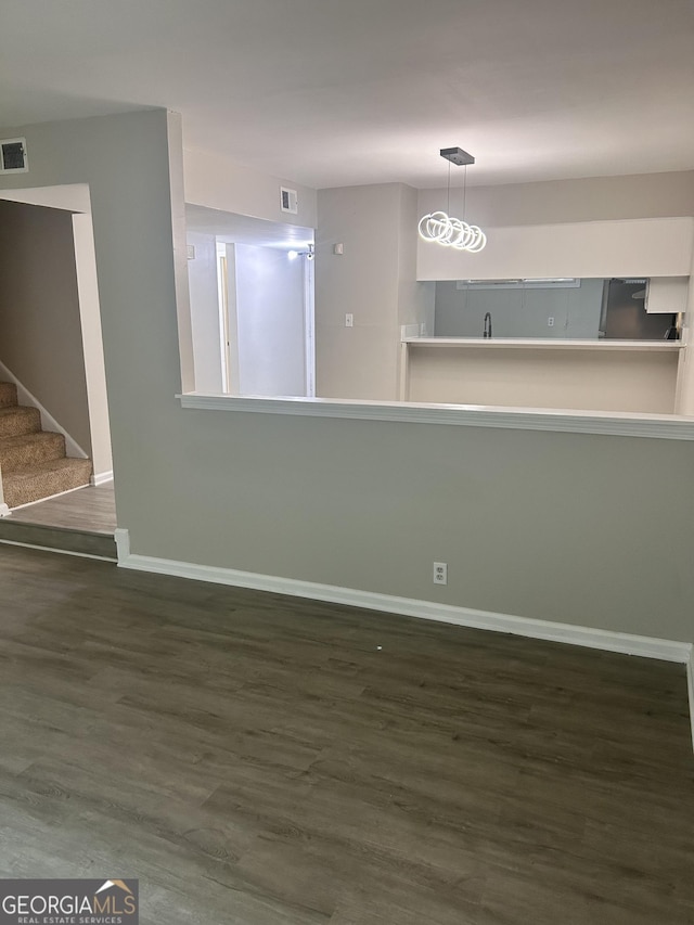 unfurnished room featuring dark wood-type flooring