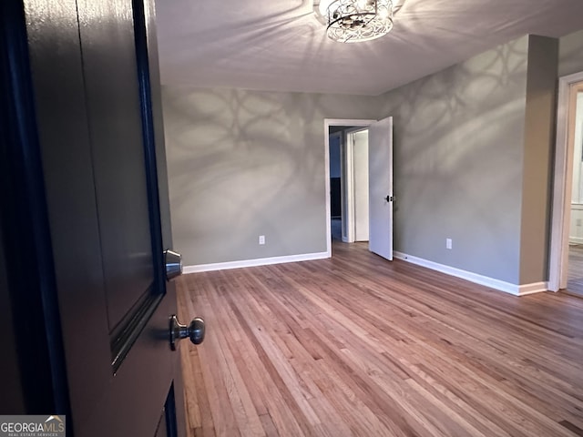 unfurnished bedroom with hardwood / wood-style floors