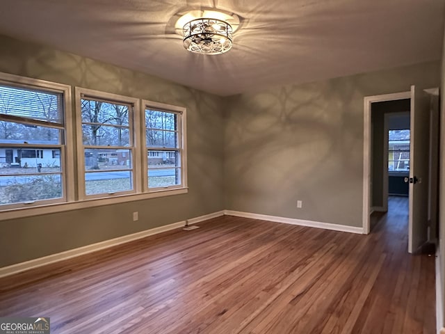 unfurnished room featuring hardwood / wood-style floors